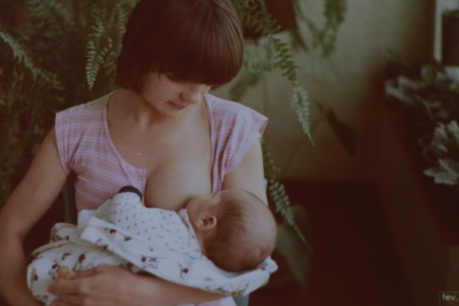 Mama karmi niemowlę piersią.