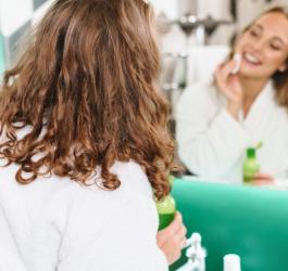 Kobieta w łazience podczas codziennej pielęgnacji skóry.