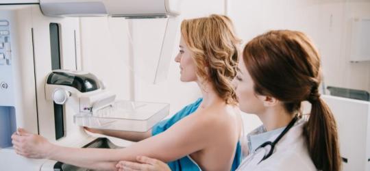 Lekarka przygotowuje pacjentkę do mammografii.