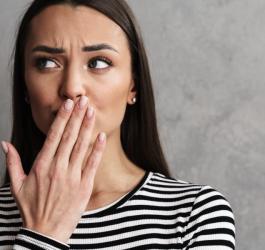 Zmartwionej kobiecie dokucza nieprzyjemny posmak w ustach.