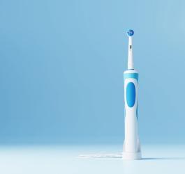 Szczoteczka soniczna na niebieskim tle.